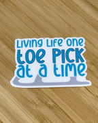 Living Life One Toe Pick At A Time Waterproof Sticker